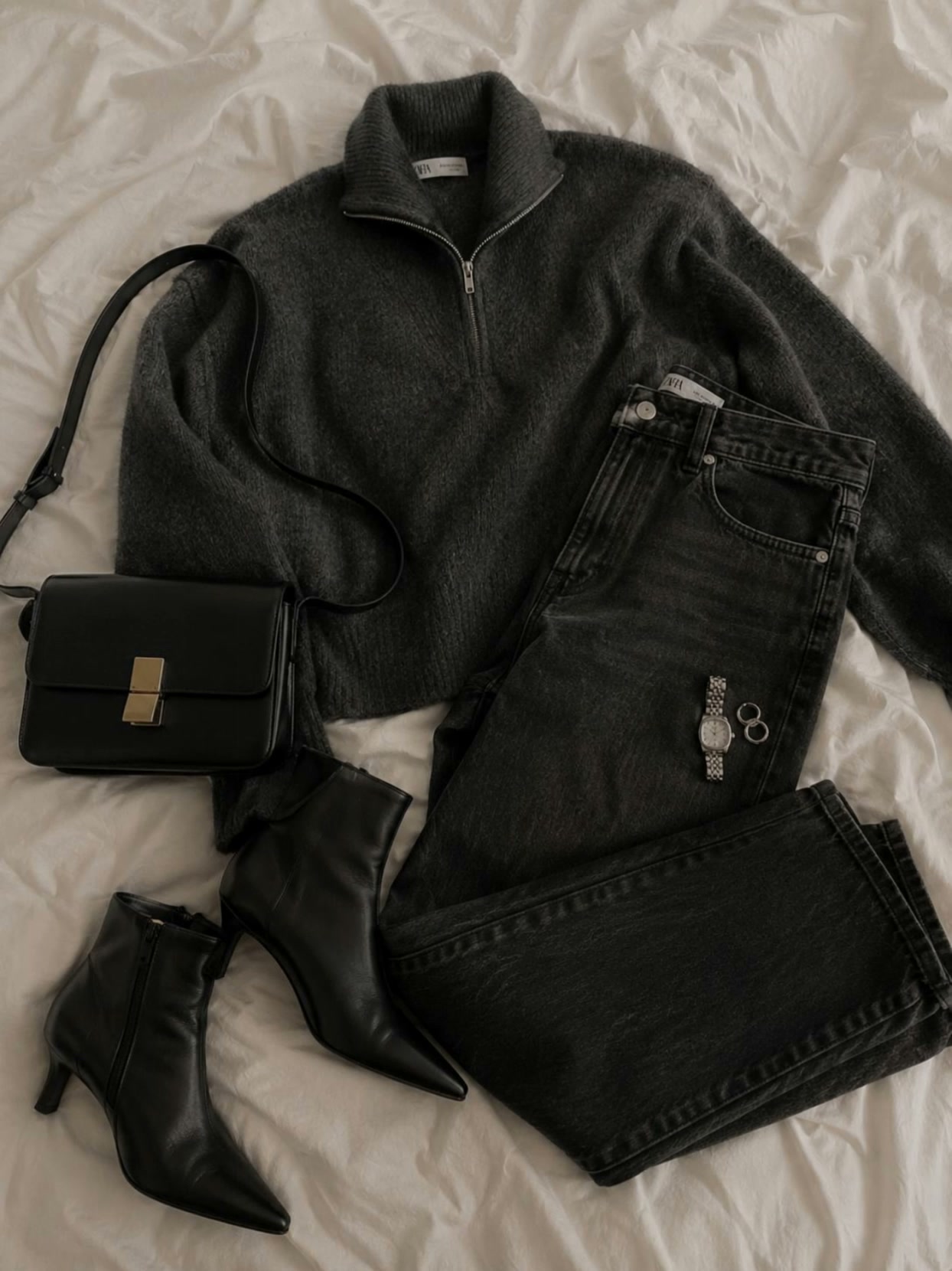 AI video result — Use the uploaded flat lay image as the exact reference for the sweater, jeans, boots, bag, jewelry, textures,…