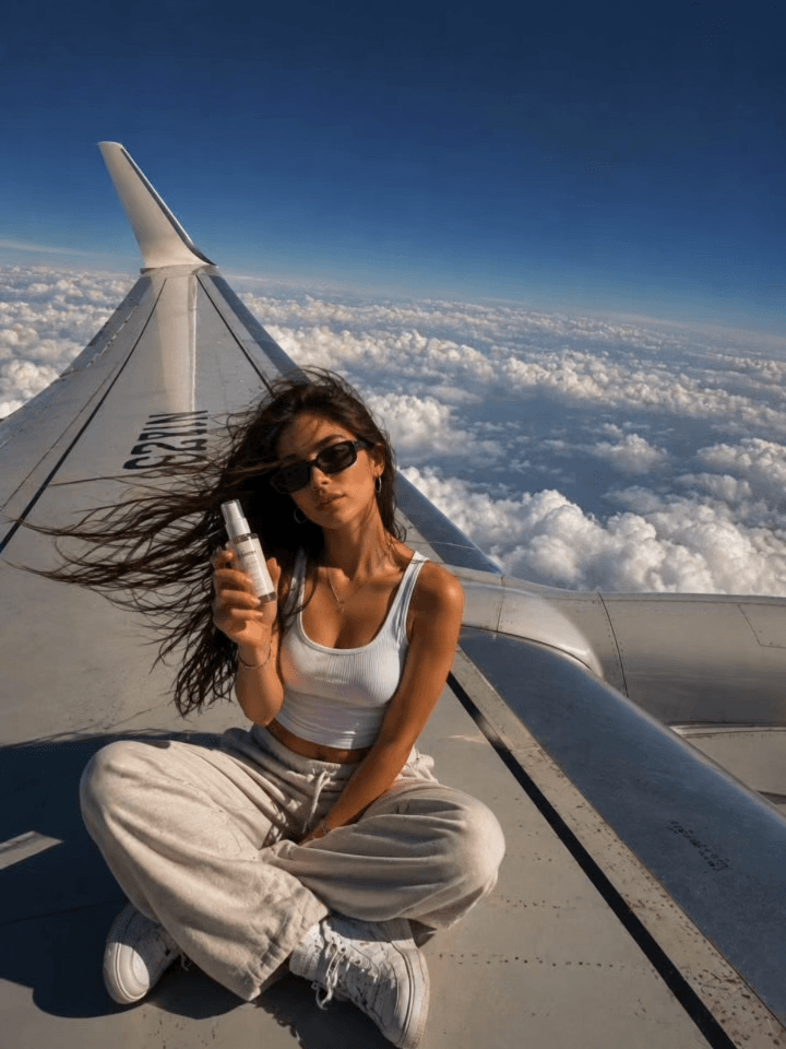 Airplane Wing location for an AI marketing video — sitting out on the airplane wing high above the clouds